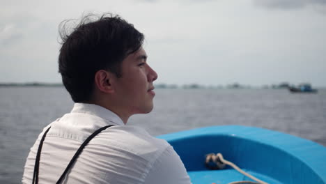 Good-Looking-Young-Guy-On-A-Boat-Floating-Over-Calm-Sea