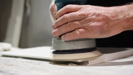 skilled worker polishing marble surface with machine