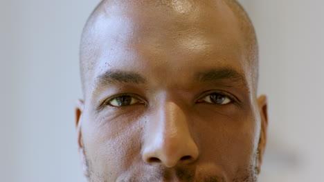 close-up of man's face with focused expression and natural lighting, at home