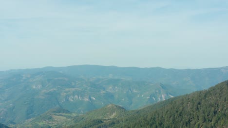 clear blue sky over the green countryside of radocelo, serbia -aerial reveal