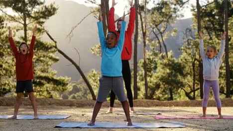 Trainer-and-kids-performing-yoga-4k