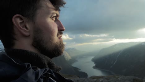 confident person reached trolltunga in norway, close up motion view