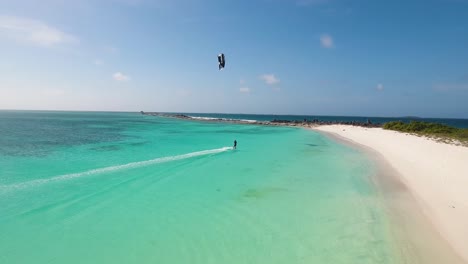 sunset kitesurfer flying from shore beach crasqui island los roques venezuela