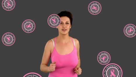 Animation-Von-Rosafarbenen-Krebsbändern-über-Einer-Laufenden-Kaukasischen-Frau