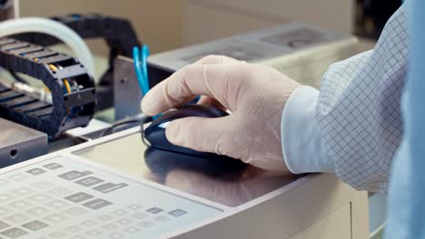 close up on a worker hand with glove working with a computer mouse