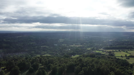 aerial shot of the countryside in the south of england with forest and farmland