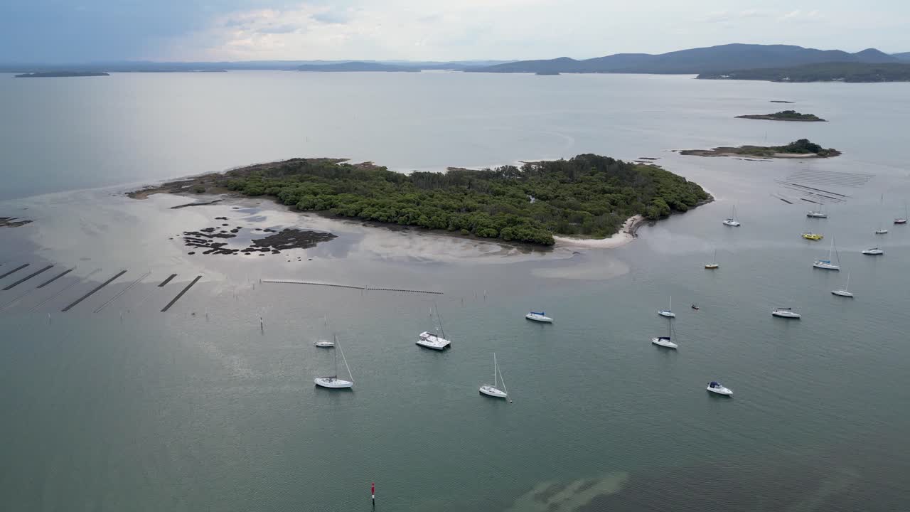 Aerial shot of Dowadee Island with a few Sailing Boats parked near by