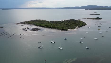 aerial shot of dowadee island with a few sailing boats parked near by