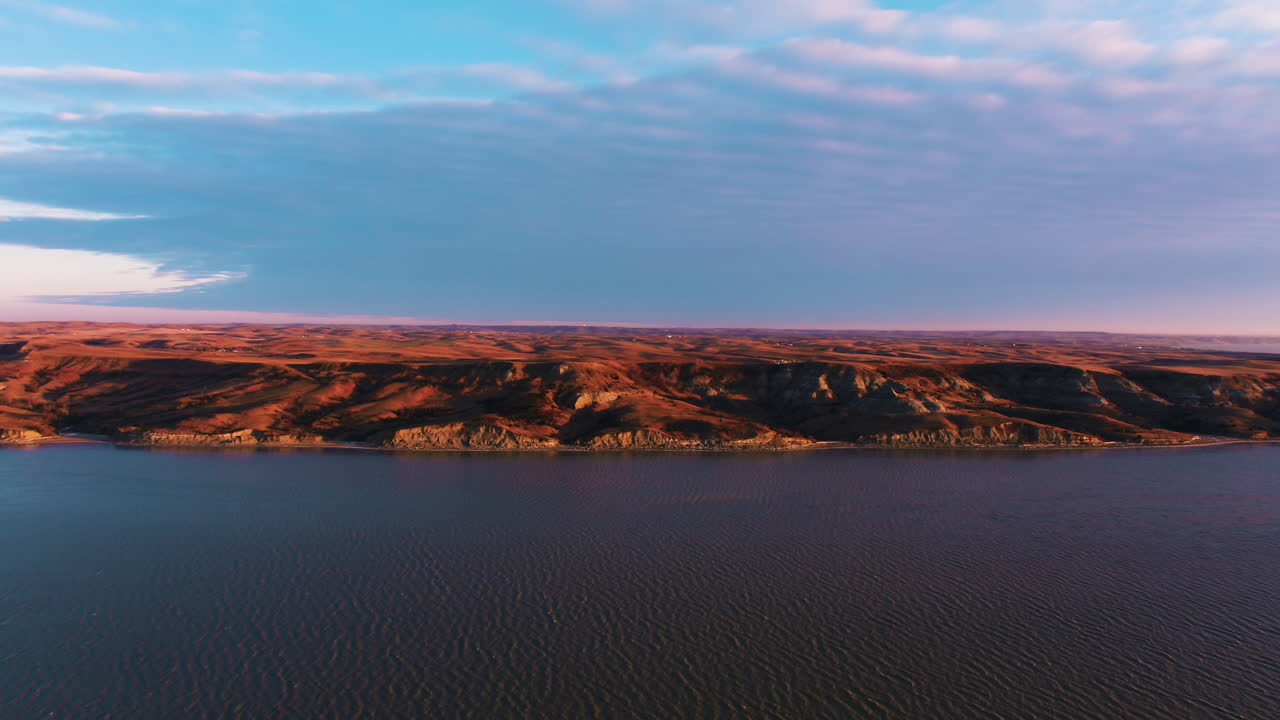 Sandstone Cliff Face Over River Sunset Wide Drone Shot