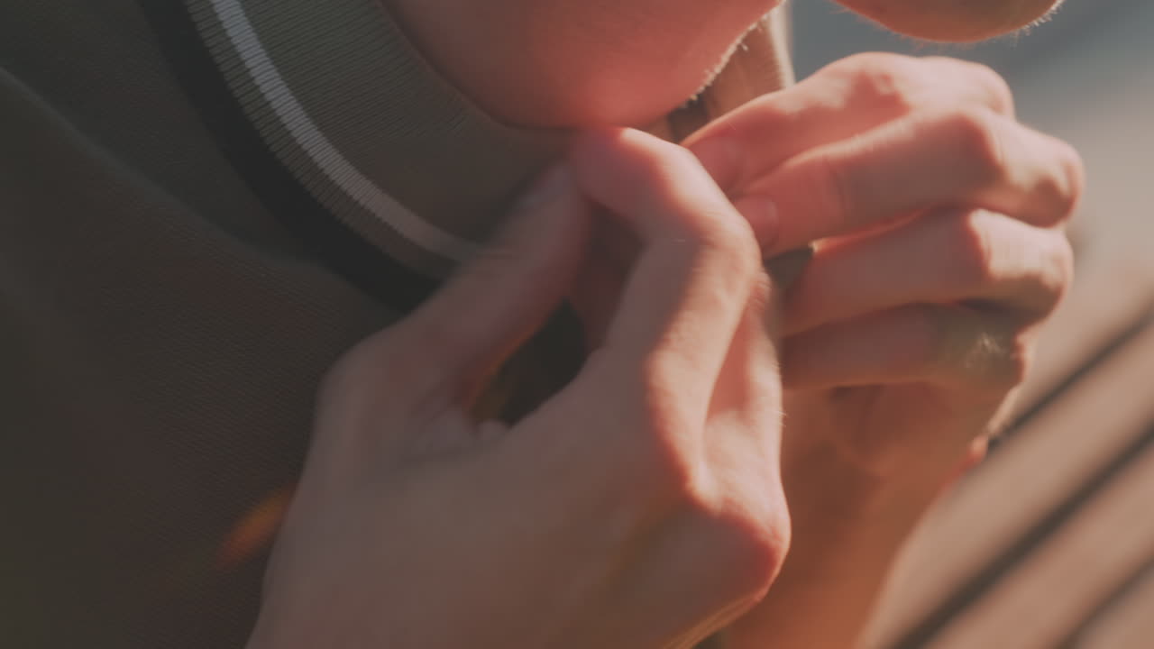 Gentleman Preparing For Social Encounter, Male Figure Meticulously Buttons Collar Prior To Friendly Social Gathering, Man Attentively Adjusts His Collar As Small Premeeting Ritual In Warm Lighting