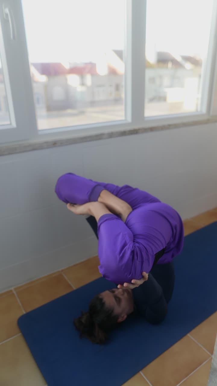 Woman practicing headstand yoga pose