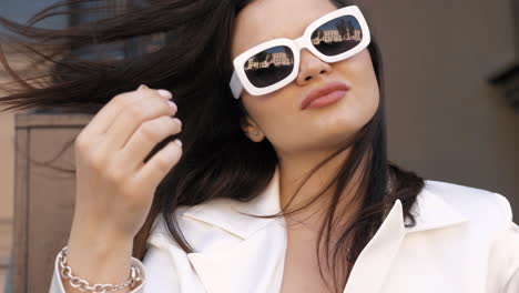 stylish woman in white blazer and sunglasses