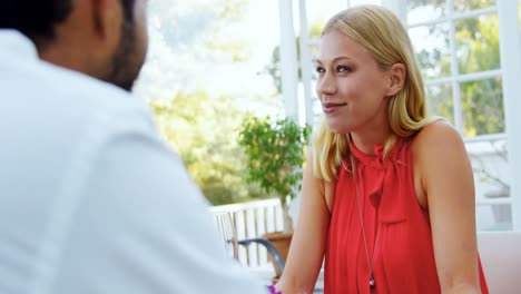 Couple-interacting-with-each-other-in-restaurant