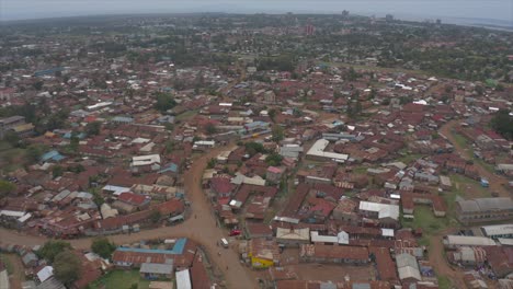 a drone shot of a residential settlement called nyalenda in kisumu showing many houses with rusted tin roofs and the road network