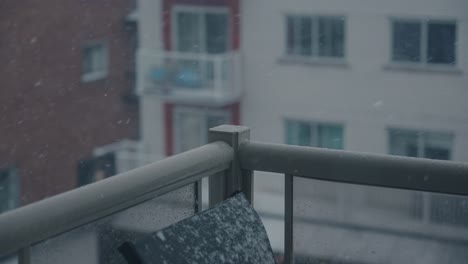 exterior day slow motion snow in 120 fps passing by balcony corner rails in focus