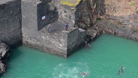 cliff diving into turquoise water