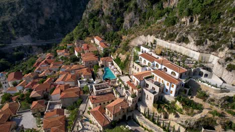 luxury resort with infinity pool and mediterranean architecture of stone walls and terraces linked by cobblestone alleys in albania