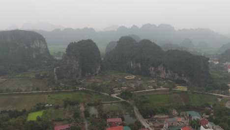 Aerial-Drone-Shot-of-Vietnam-City-Ninh-Binh-with-Hills-And-Mountains