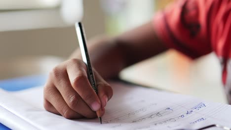 boy learning to write on his notebook