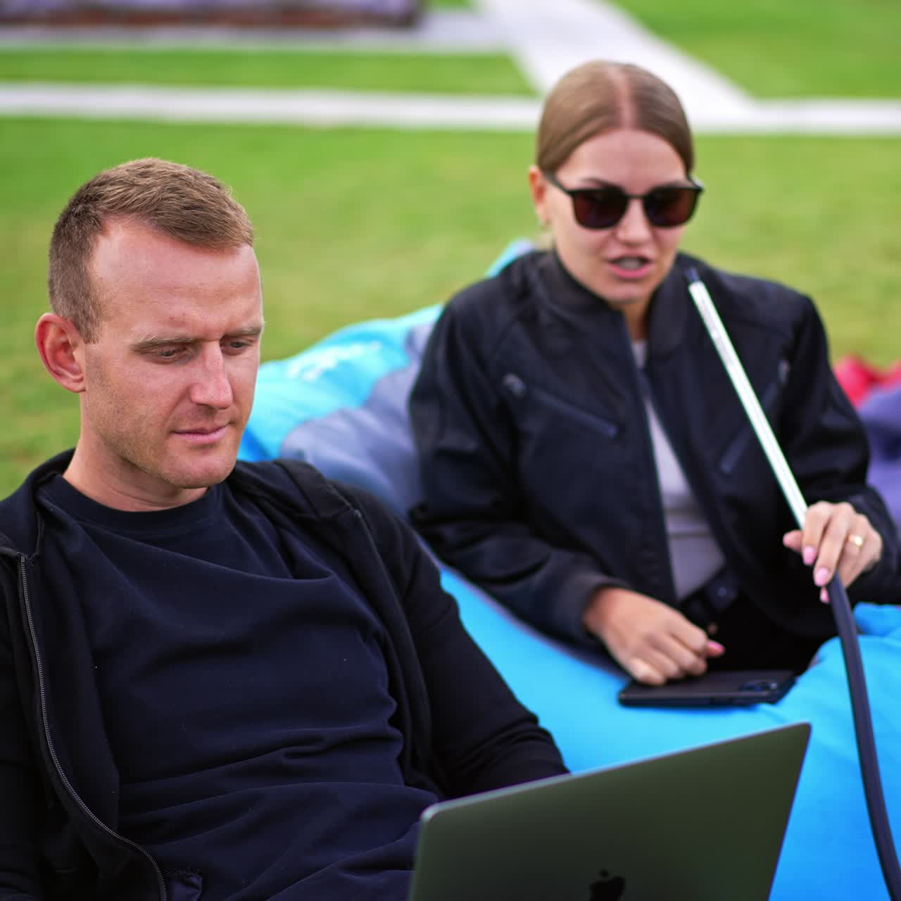 Outdoor having fun with hookah. Young couple relaxing together