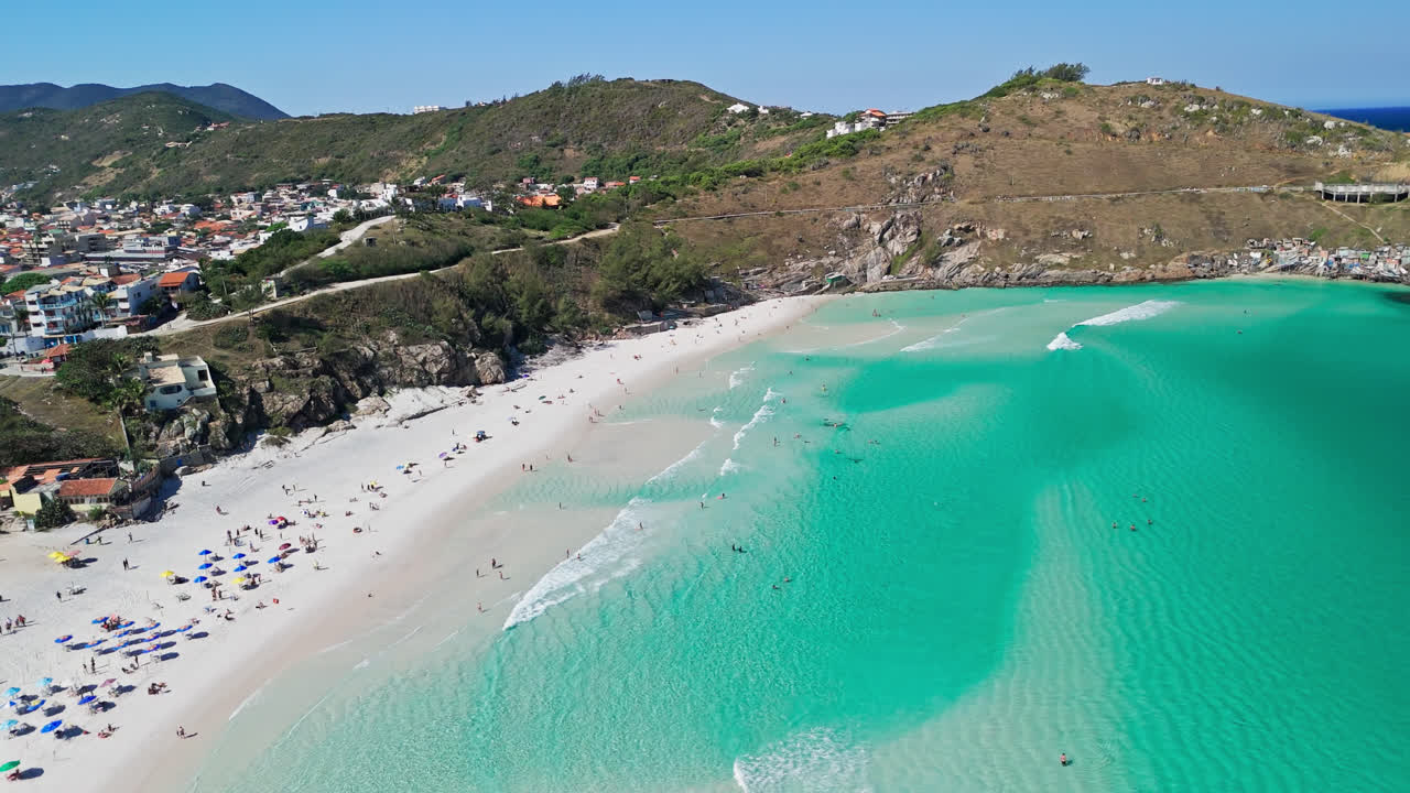 Aerial view of Arraial do Cabo, people sunbath on gleaming white sand, Brazil wonder