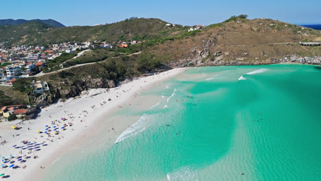 aerial view of arraial do cabo, people sunbath on gleaming white sand, brazil wonder