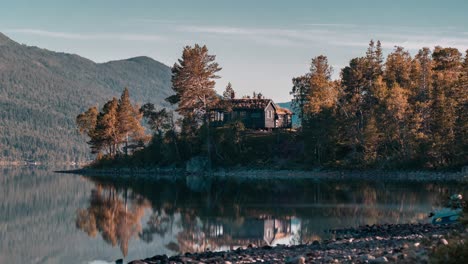 a view of the solitary cabin by the lake