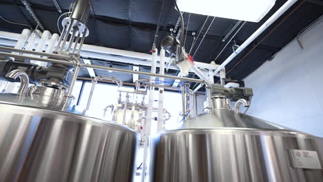 stainless stills in brewery, beer manufacturing equipment in warehouse, 4k