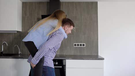 couple watching the apartment and boyfriend carrying the woman on piggyback