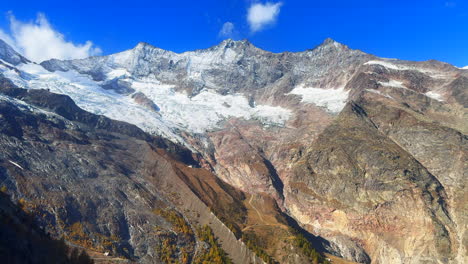 Saastal-Saas-Fee-Switzerland-tram-ride-top-of-Swiss-Alps-glacier-mountain-peaks-summer-morning-stunning-vibrant-clear-blue-sky-alpine-valley-fresh-snow-dusting-Zermatt-Alphabel-gimbal-glide-slide