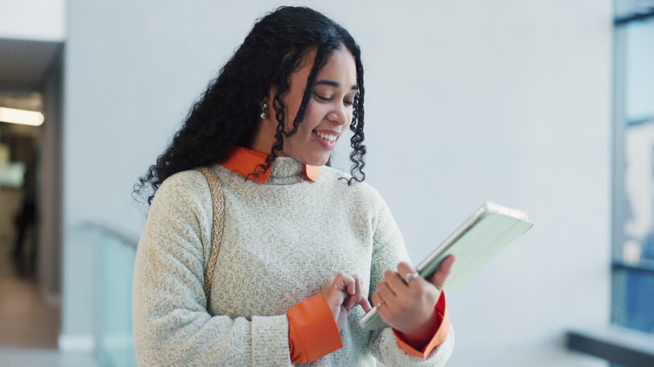 Young Woman Smiling While Using Digital Tablet Indoors