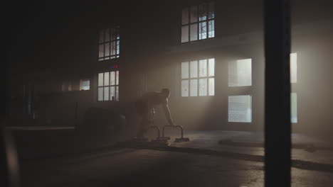 man performing handstand push-ups in a gym
