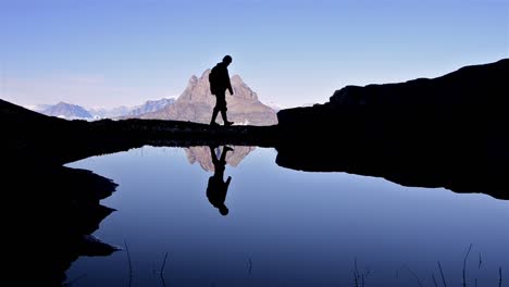 hiker silhouette in front of uummannaq mountain at qilakitsoq near uummannaq greenland