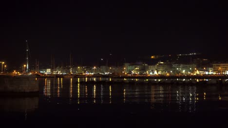 illuminated waterfront at night of rethmyno, crete, greece. locked wide shot