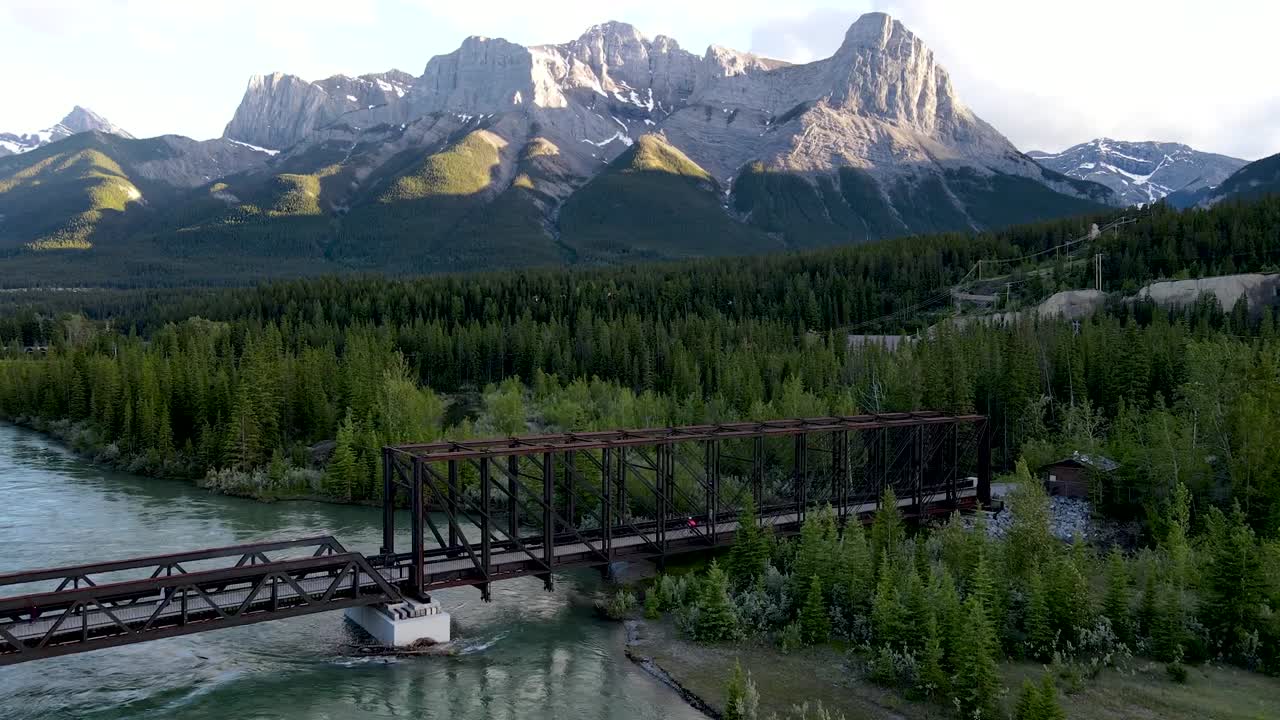Drone shot toward mountain + bridge