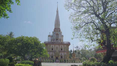 buddhist famous landmark pagoda at wat chalong phuket, thailand. pov camera wide shot.