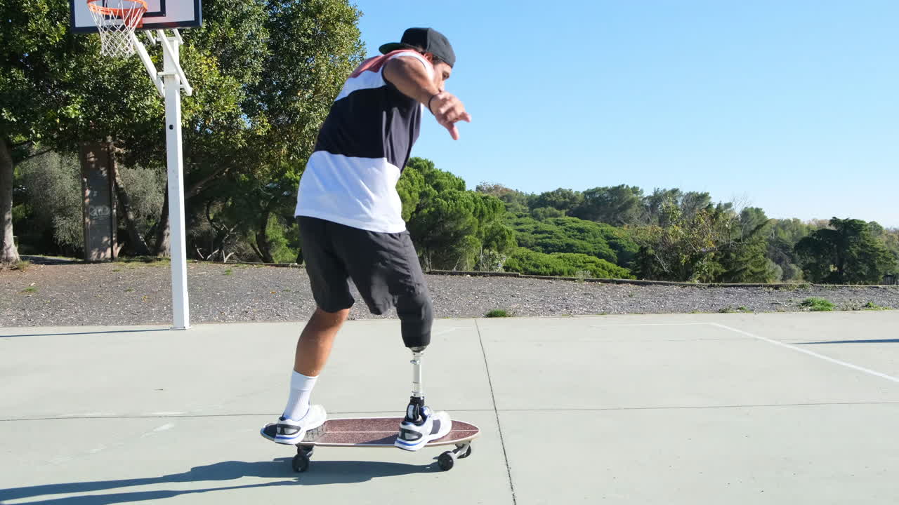 Sporty man with leg prosthesis stepping on skateboard