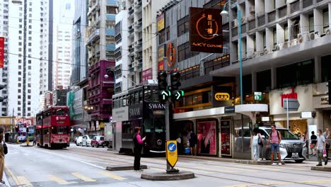 tram moves through busy hong kong street