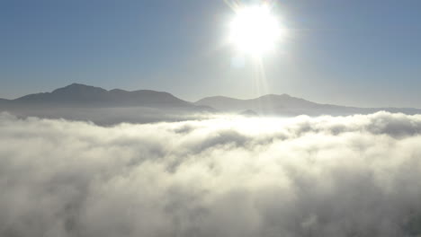 aerial view of low fog over mountains in san diego during sunrise