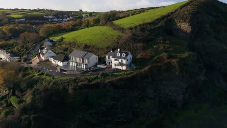 flying towards a lonely house standing on the edge of the emerald hill