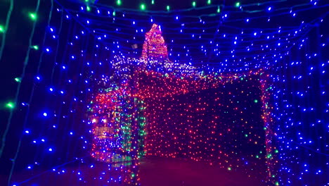 exiting tunnel of thousands of christmas lights at night