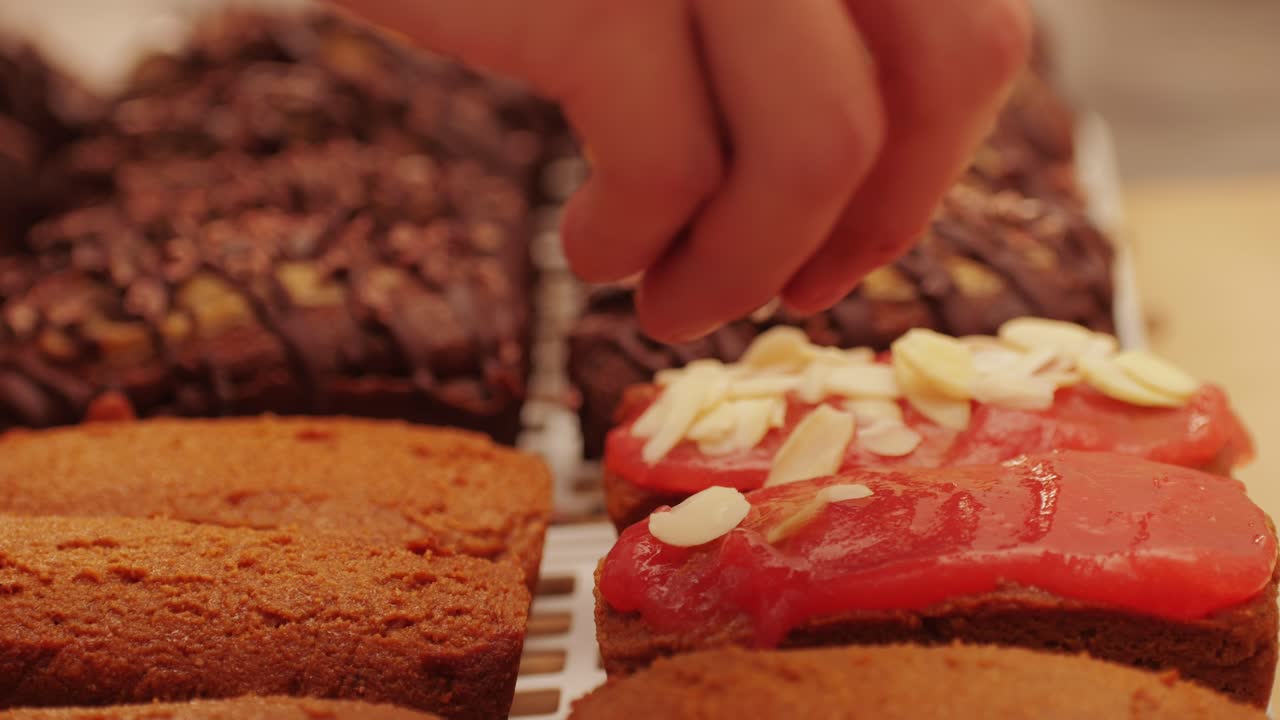 Artezan bread with red strawberry jam on top, fresh bake double chocolate banana artesian bread in bakery shop close-up. Artisan bread is making by skill bakers using natural and high-quality ingredients. Food with health and flavour benefits. Sweet breads for dessert and breakfast