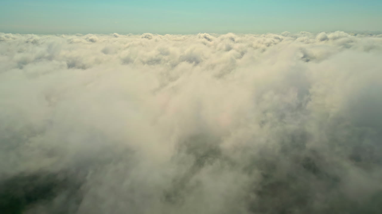 Drone aerial pan landscape of cloud coverage overcast misty haze fog smoke in sky peaceful horizon skyline atmosphere weather cumulus nimbus meteorology climate