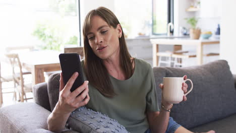 Middle-aged-Caucasian-woman-enjoys-a-cozy-moment-at-home