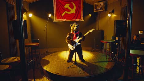 bear musician on stage with soviet flag