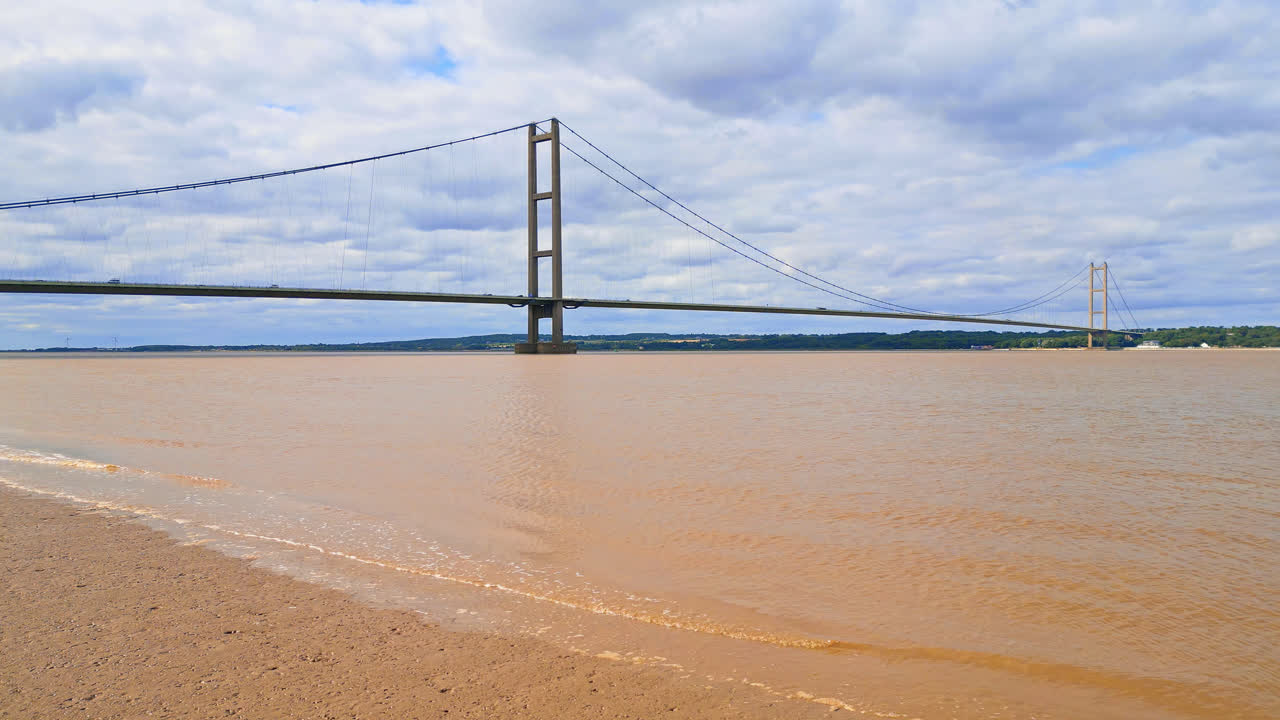 A drone video shows Humber Bridge, 12th largest suspension span, crossing River Humber, linking Lincolnshire to Humberside amid traffic