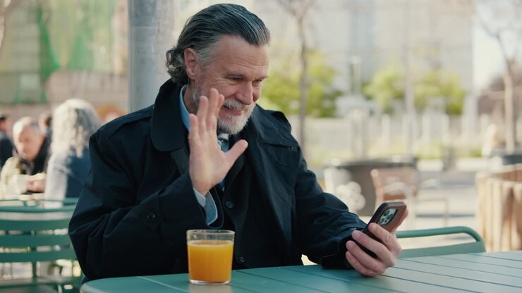 Businessman Video Chatting at Outdoor Cafe