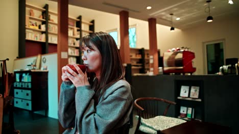 woman enjoying a drink in a cozy cafe