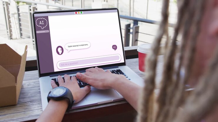 Biracial businessman using laptop with ai digital chat on screen in office