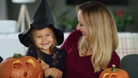 Happy-mother-and-daughter-with-Halloween-pumpkins